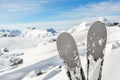 Close-up pair of skis on mountain winter resort with ski-lift and beautiful winter mountain panoramic scenic view Royalty Free Stock Photo