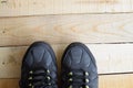 Close up of a pair of sport shoes on wood panels Royalty Free Stock Photo