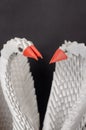 Close-up of a pair of white paper swans. A symbol of love and fi