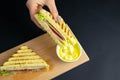 Close up on pair of young girl`s hands removing a healthy wholesome wholemeal bread ham sandwich Royalty Free Stock Photo