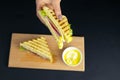 Close up on pair of young girl`s hands removing a healthy wholesome wholemeal bread ham sandwich Royalty Free Stock Photo