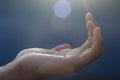 Close up of palm hand open receiving the light of blessings. Fragility and hope concept.