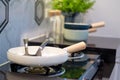 Close-up pan for cooking on the stove with modern kitchenware sets