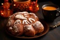 close-up of a pan de muerto traditional bread with a cup of hot chocolate