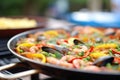 close-up on pan edge, showing socarrat of a well-cooked paella Royalty Free Stock Photo