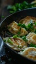 Close-up of pan-fried dumplings with green onions