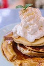 Close up Pancakes with caramel-banana syrup topping with whip cream and mint leaves Royalty Free Stock Photo