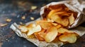 Close-up of a paper bag with apple chips poured onto a paper sheet on a dark table. Natural healthy dried product.