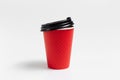 Close-up of paper cup with black plastic lid for coffee takeaway of red color isolated on white studio background Royalty Free Stock Photo