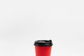 Close-up of paper cup with black plastic lid for coffee takeaway of red color isolated on white studio background with copy space Royalty Free Stock Photo