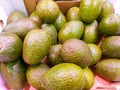 a paperboard box at the market plenty of tasty brilliant green avocados just harvested ready to be sold to customers Royalty Free Stock Photo