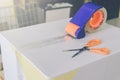 Preparing parcel for shipping with scissors and scotch tape cutter. Royalty Free Stock Photo