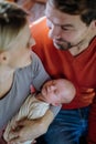 Close-up of parents cuddling their newborn baby. Royalty Free Stock Photo