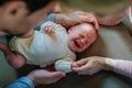 Close-up of parents cuddling their newborn crying baby. Royalty Free Stock Photo