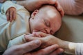 Close-up of parents cuddling their newborn crying baby. Royalty Free Stock Photo
