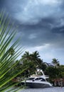 Parked boat at dock on canal over storm sky in Florida Royalty Free Stock Photo