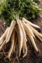 Close-up parsnip with parsley top on wooden board Royalty Free Stock Photo