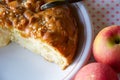 Close up of a part of apple pie on a white plate