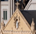 Close up of part of church roof with cross and sculpture religious symbolism interesting shape