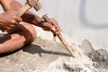 Close up Part of a construction labor working with hammer and Chisel in a construction site Royalty Free Stock Photo