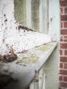 Close up of part of a dilapidated and neglected rotten wooden window frame