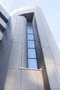 Close-up part of a modern building with a smooth facade. Low angle of shot. Royalty Free Stock Photo