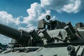 Close-up of part of old military tank with tower against blue sky Royalty Free Stock Photo