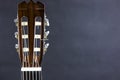 CLOSE-UP Part of a orange acoustic guitar on black background. Royalty Free Stock Photo