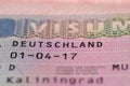 close-up part of page of document, foreign passport for travel with German visa, tourist schengen visa stamp with hologram with Royalty Free Stock Photo