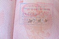 close up part of pages of foreign passport with foreign visas, border stamps, permits to enter countries, concept of traveling Royalty Free Stock Photo