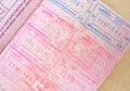 close up part of pages of foreign passport with foreign visas, border stamps, permits to enter countries, concept of traveling Royalty Free Stock Photo