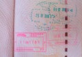 close up part of pages of foreign passport with foreign visas, border stamps, permits to enter countries, concept of traveling Royalty Free Stock Photo