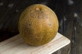 close-up of a part of a ripe whole melon on the table