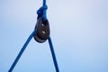 Close up of part of sailboat rigging with rope and metal parts.