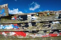 Coloured paint flaking on an old wooden boat.