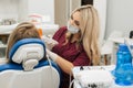 Close-up partial view of dentist using dental curing UV lamp on teeth of patient Royalty Free Stock Photo