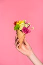 close-up partial view of woman holding ice cream cone with beautiful flowers Royalty Free Stock Photo