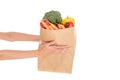 close-up partial view of woman holding paper bag with fruits and vegetables Royalty Free Stock Photo