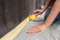 Close-up partial view of young woman kneeling and working with tape Royalty Free Stock Photo