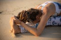 Close up of Paschimottanasana, Seated Forward Bend Pose. Woman practicing yoga on the beach. Hands holding big toes. Yoga retreat Royalty Free Stock Photo