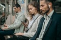 passengers with smartphones sitting in a subway car . Royalty Free Stock Photo
