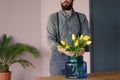 Close-up of passionate gardener taking care of yellow flowers in