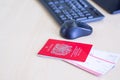 Close-up of passport and plane tickets placed on the desk near the computer. Prepare for travel. Holiday concept Royalty Free Stock Photo