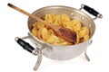 Angled pasta colander with wooden spoon close-up on white background