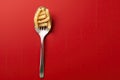 Close up of pasta isolated on red background in spoon or fork Royalty Free Stock Photo