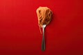 Close up of pasta isolated on red background in spoon or fork Royalty Free Stock Photo