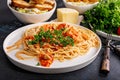 Close-up pasta with meat in tomato sauce and fresh parsley. Fresh vegetable salad with cheese and croutons. Dinner or lunch in Royalty Free Stock Photo