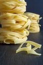 Close-up of pasta with pile of fettuccine defocused posterior on black background