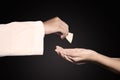 Pastor giving first communion bread to woman