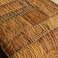 Close-up of a patchwork fabric featuring various shades of brown and tan. The texture Royalty Free Stock Photo